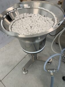 vibrating adjuster for plastic caps